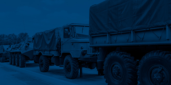 Military trucks and armoured vehicles parked in a row